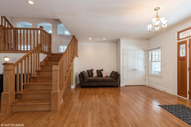 foyer featuring baseboards, ornamental molding, and wood finished floors