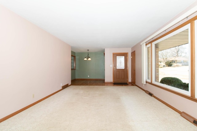 interior space with a notable chandelier and baseboards