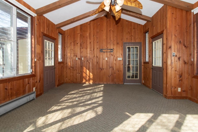 entryway featuring lofted ceiling with beams, a baseboard radiator, a wealth of natural light, and wooden walls