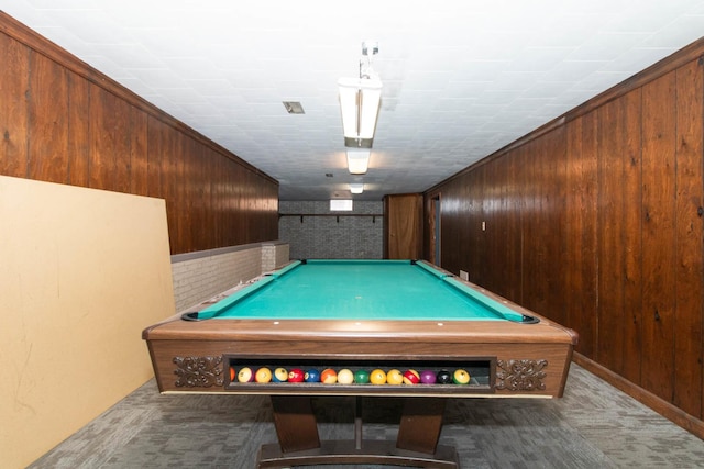 rec room with carpet, wooden walls, and pool table