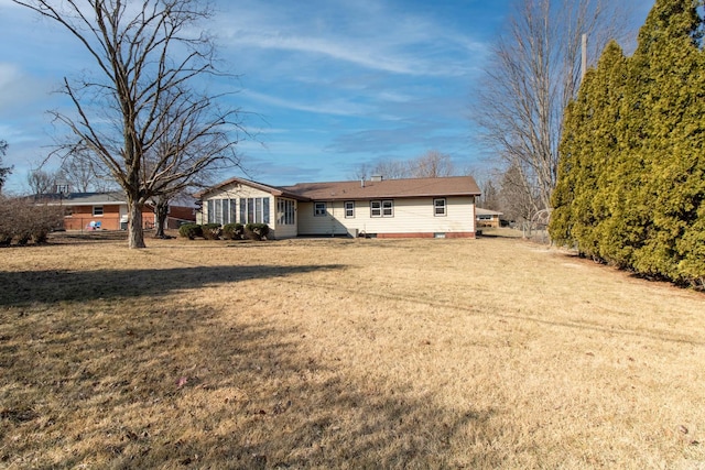 rear view of house with a yard