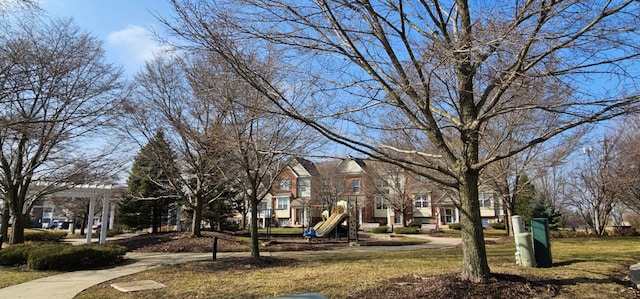 view of property's community featuring a residential view, playground community, and a yard