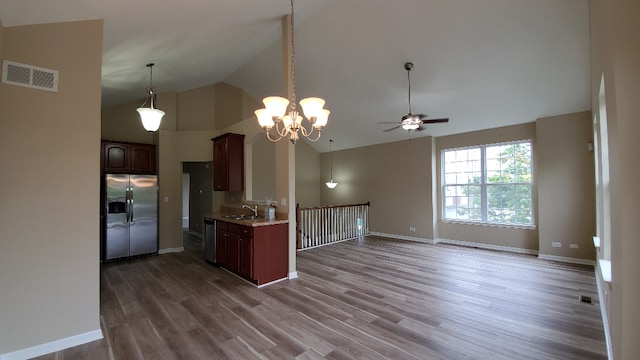 kitchen with dishwasher, dark wood-style floors, light countertops, stainless steel refrigerator with ice dispenser, and a sink