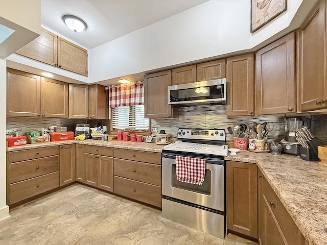 kitchen with stainless steel appliances, tasteful backsplash, and brown cabinets