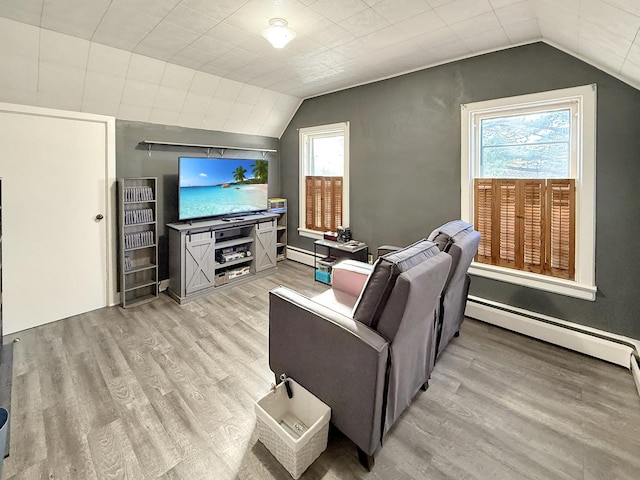 living room with light wood-type flooring, lofted ceiling, and baseboard heating