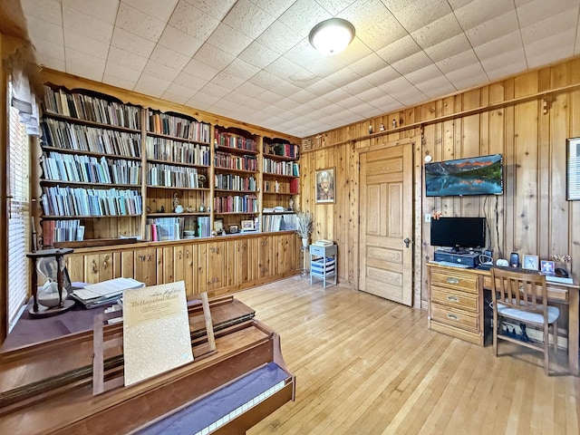 office featuring wood-type flooring and wood walls