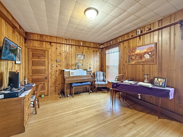 office featuring wood-type flooring and wooden walls