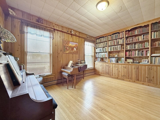 office area featuring wood walls and wood finished floors