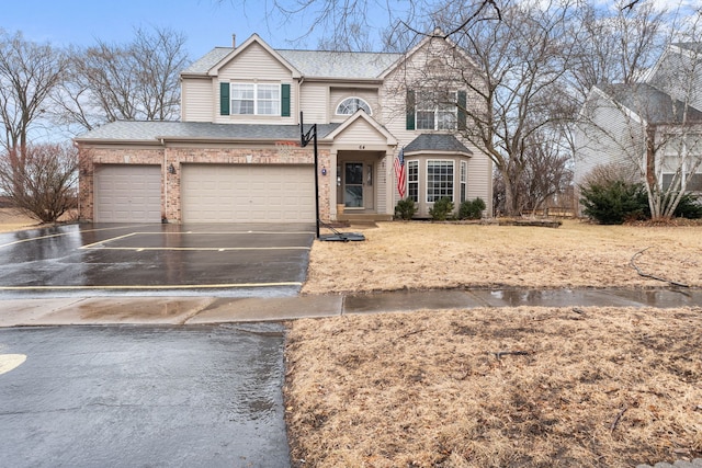 view of front of house with roof with shingles, concrete driveway, and brick siding