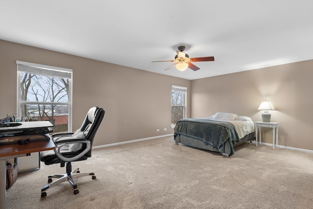 carpeted bedroom with baseboards and a ceiling fan