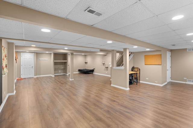 finished below grade area with recessed lighting, visible vents, baseboards, and wood finished floors