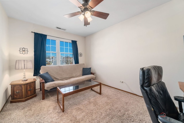 carpeted office space featuring baseboards, visible vents, and a ceiling fan