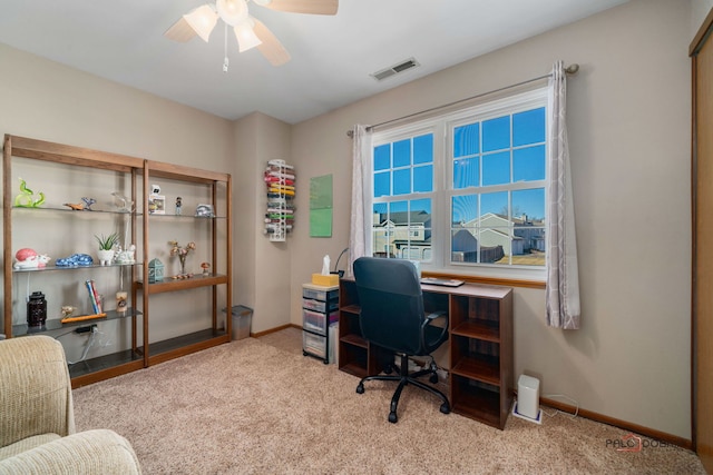 office area with carpet floors, a ceiling fan, visible vents, and baseboards