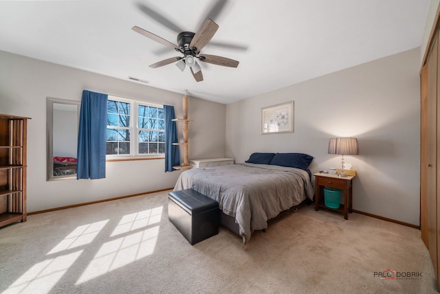 carpeted bedroom with visible vents, ceiling fan, and baseboards