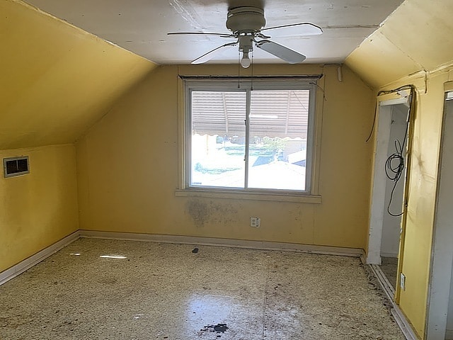 bonus room featuring vaulted ceiling, ceiling fan, and baseboards