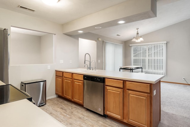 kitchen featuring visible vents, appliances with stainless steel finishes, a peninsula, light countertops, and a sink