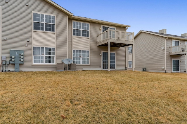 rear view of property with a yard