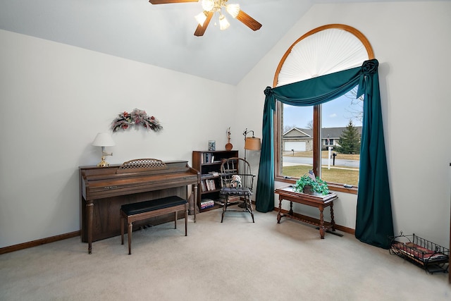 living area with a ceiling fan, carpet, lofted ceiling, and baseboards