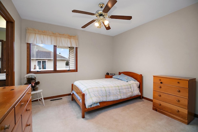 bedroom with light carpet, baseboards, visible vents, and ceiling fan