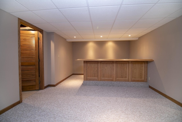 bar featuring recessed lighting, light carpet, a paneled ceiling, and baseboards