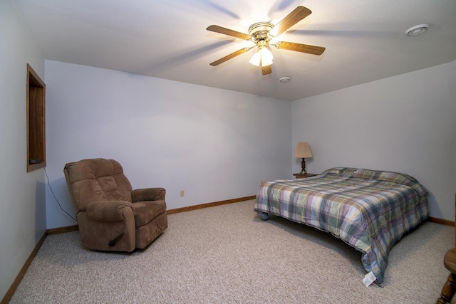 bedroom with light colored carpet, ceiling fan, and baseboards