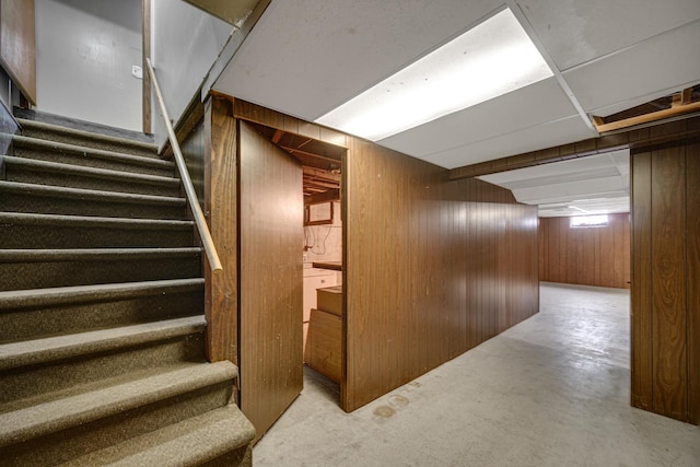 interior space featuring wooden walls and concrete flooring