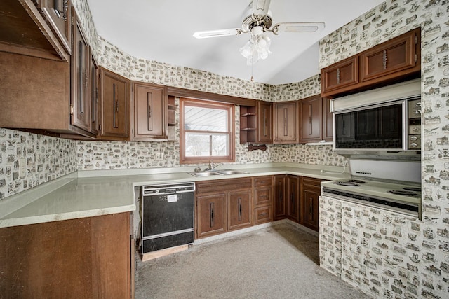 kitchen featuring a sink, light countertops, dishwasher, open shelves, and wallpapered walls