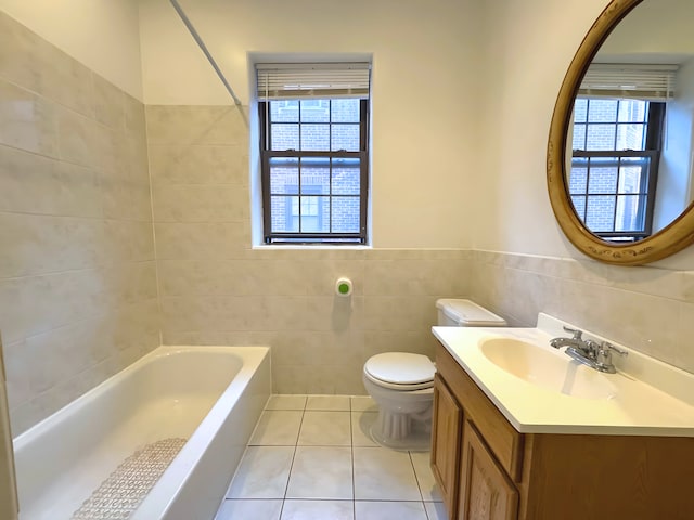 full bathroom featuring a washtub, tile walls, toilet, vanity, and tile patterned flooring