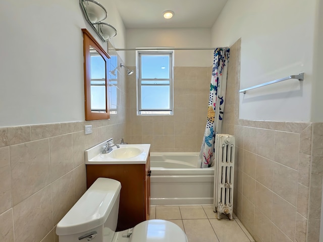 bathroom featuring tile patterned flooring, toilet, tile walls, and radiator heating unit