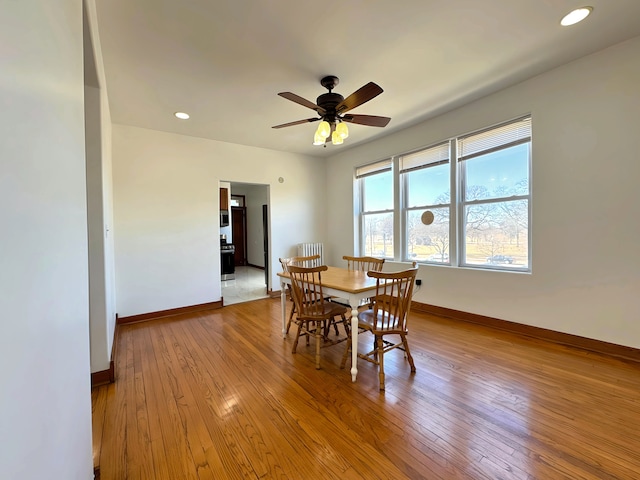 dining area with hardwood / wood-style flooring, baseboards, a ceiling fan, and recessed lighting