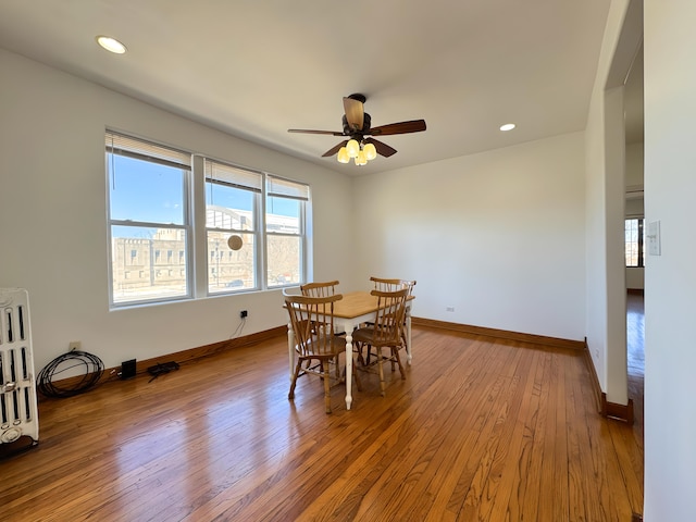 dining area featuring wood-type flooring, baseboards, a ceiling fan, and recessed lighting