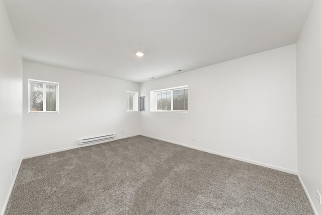 spare room with electric panel, baseboards, a baseboard radiator, dark colored carpet, and recessed lighting