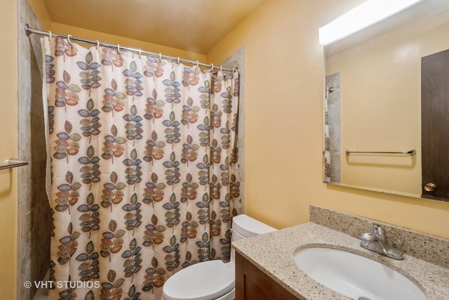 bathroom featuring a shower with shower curtain, toilet, and vanity