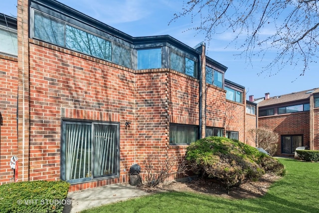 rear view of property featuring brick siding