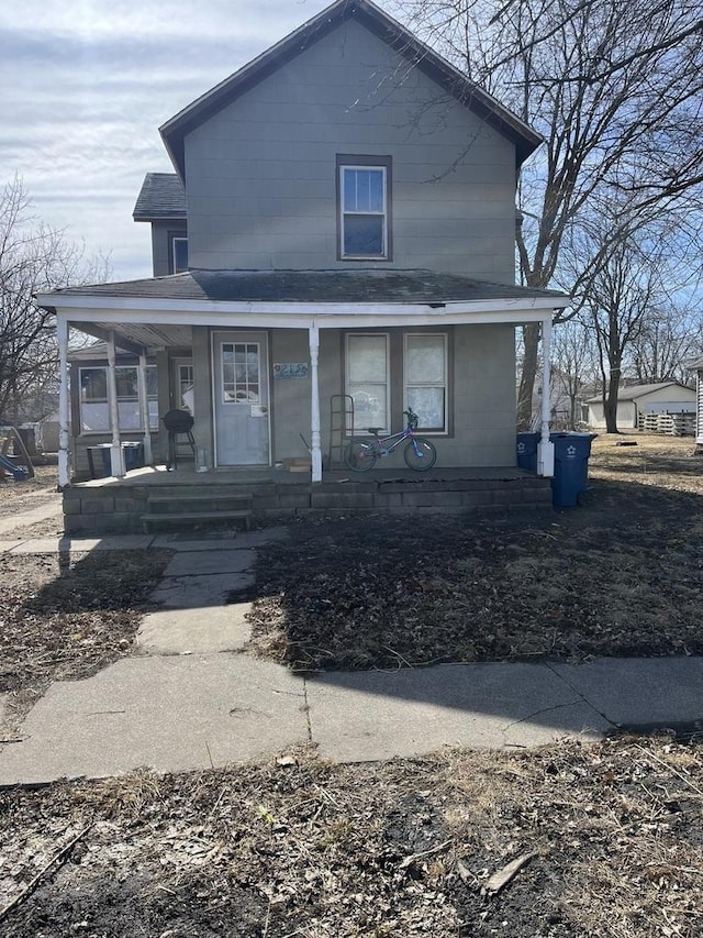 view of front of home with a porch and roof with shingles