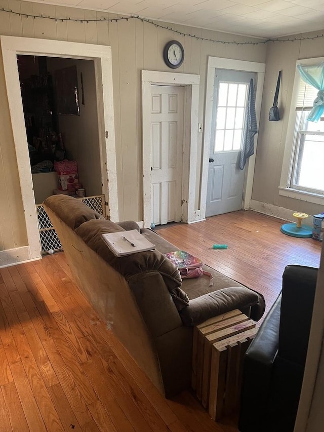 living area with hardwood / wood-style flooring and baseboards