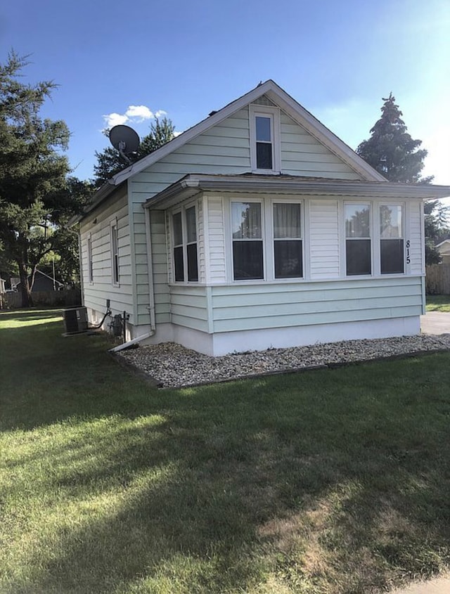 view of side of property with a yard