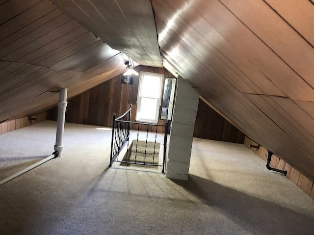 unfinished attic with an upstairs landing