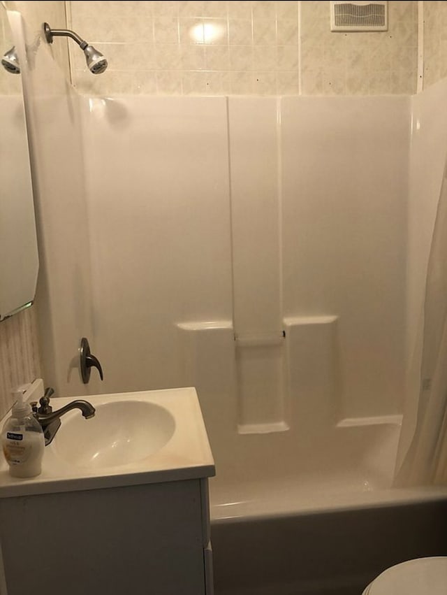 bathroom with toilet, shower / bathtub combination with curtain, visible vents, and vanity