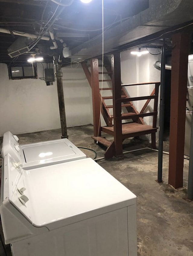 unfinished basement with washing machine and dryer and stairway