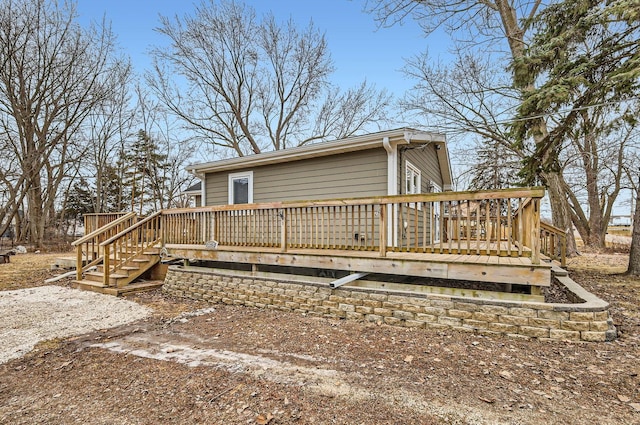 rear view of property featuring a deck