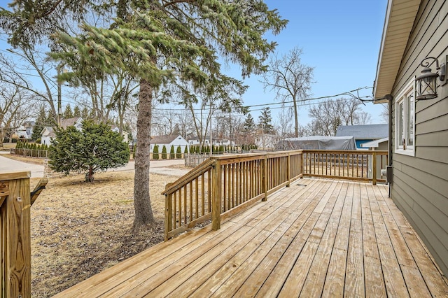 wooden deck featuring a residential view and fence