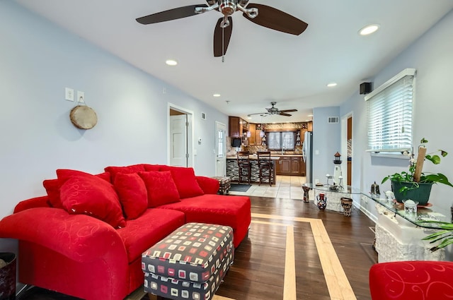 living room featuring recessed lighting, visible vents, and wood finished floors