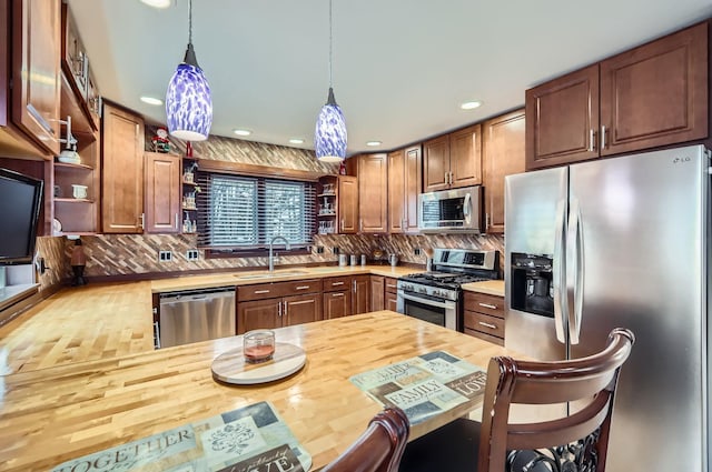 kitchen with a sink, appliances with stainless steel finishes, open shelves, and wooden counters