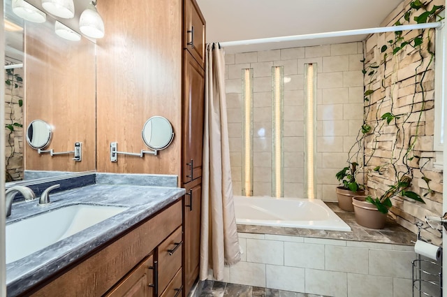 bathroom featuring tiled shower / bath and vanity