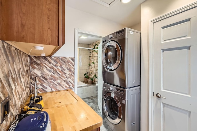 laundry room with stacked washing maching and dryer