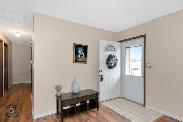 entryway with light wood-style floors, visible vents, and baseboards