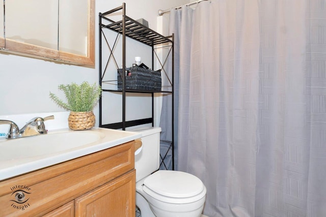 bathroom with vanity, toilet, and a shower with curtain