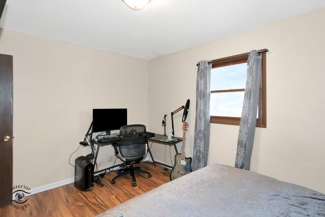 bedroom with wood finished floors and baseboards