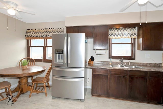 kitchen featuring ceiling fan, a sink, dark brown cabinets, stainless steel refrigerator with ice dispenser, and plenty of natural light